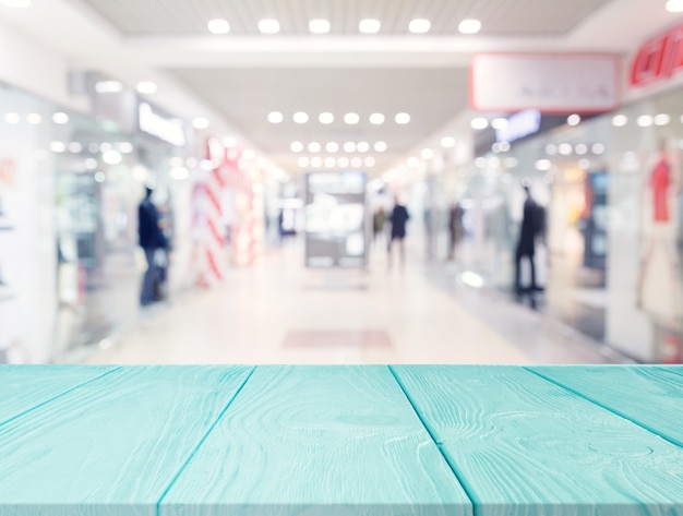 Free photo turquoise wooden table in front of shopping mall