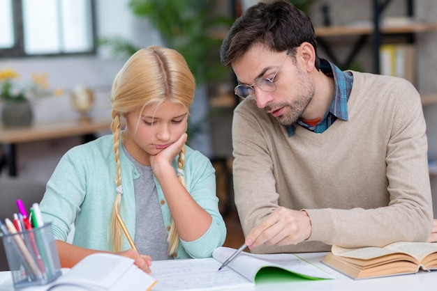 Free Photo tutor and girl at home front view