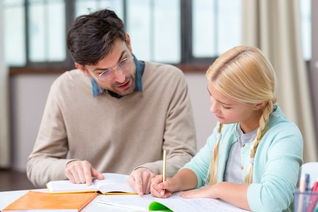 Free photo tutor and girl at home writing new information