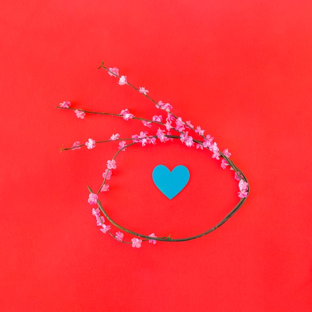 Free photo twig with flowers in form of circle and paper heart