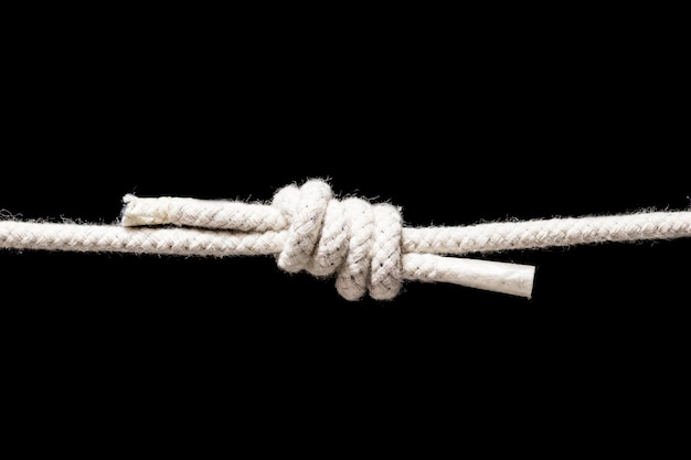 Free photo twine strong white rope isolated on black background