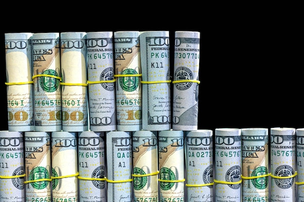 Free Photo twisted dollar bills on a black background finance concept background