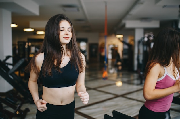 Two athletic girls in the gym