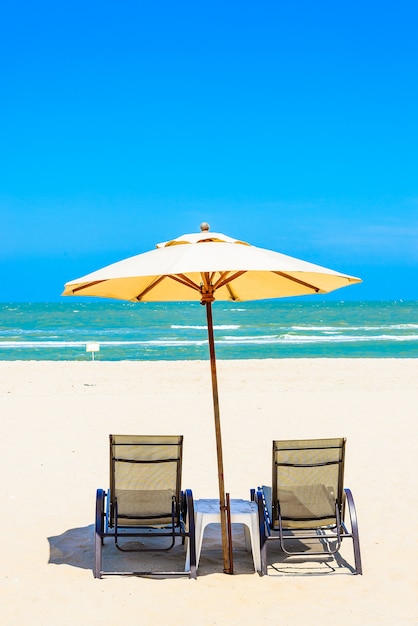 Two beach chairs on white sand