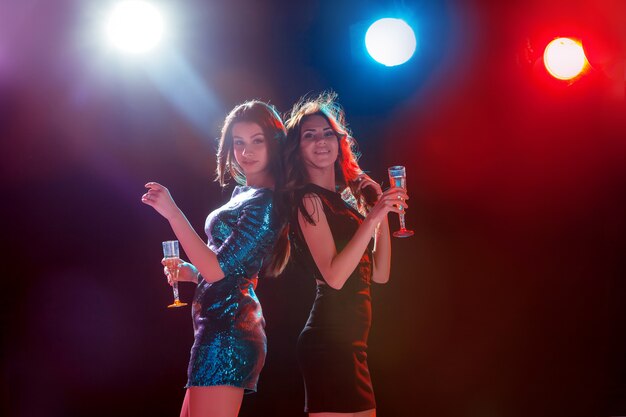 Two beautiful girls dancing at the party