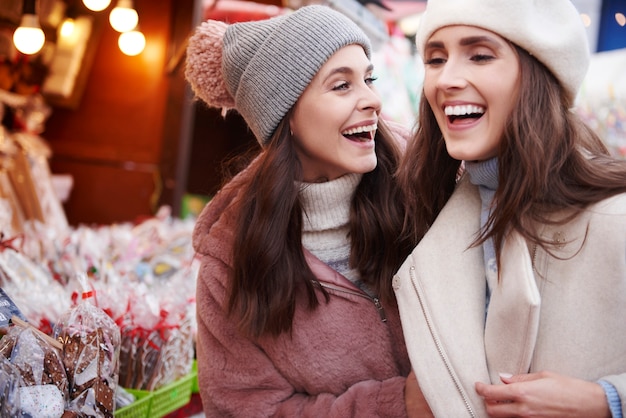 Two best friends having fun on Christmas market