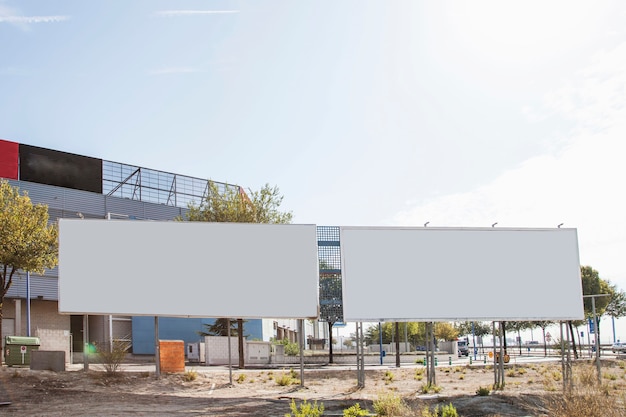 Two blank white billboards