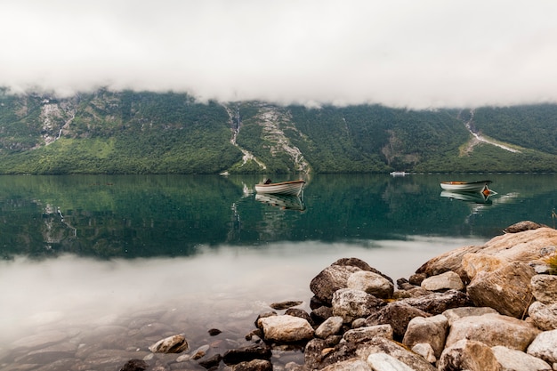 Free Photo two boats on beautiful mountain lake