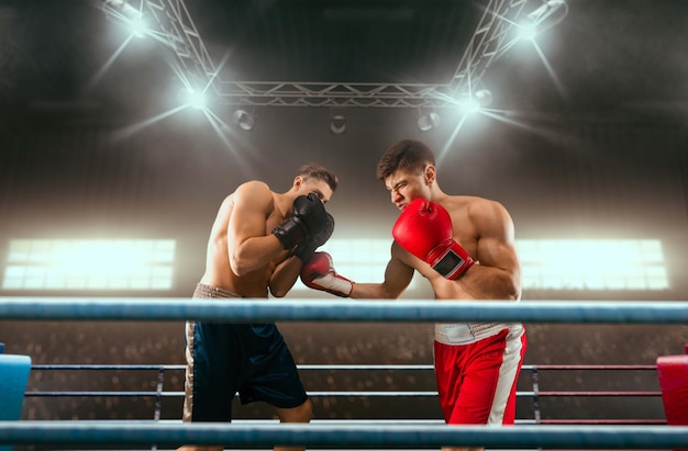 Free Photo two boxers are fighting on professional boxing ring