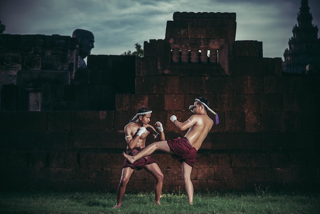 Free photo two boxers fight with the martial arts of muay thai.