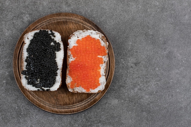 Two bread slices with fresh caviar. Top view