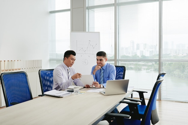 Two business executives negotiating the contract in the conference room