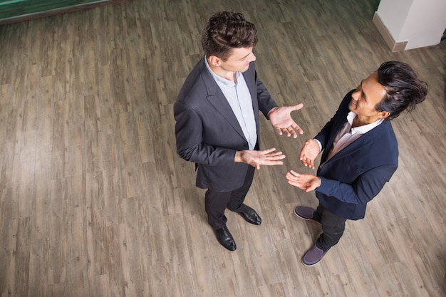 Free Photo two business men discussing ideas in office hall