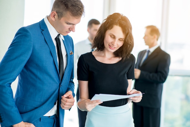 Two business partners examining document in office