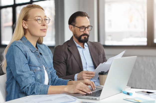 Two business partners do paperwork