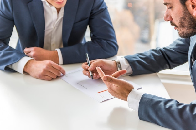 Two businessman analyzing company financial report