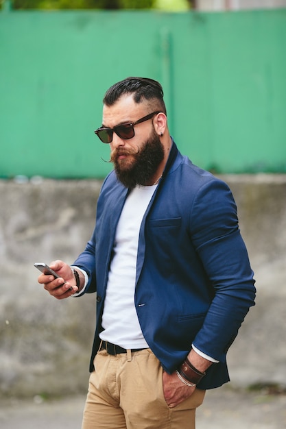 Two businessmen talking on the phone in the city