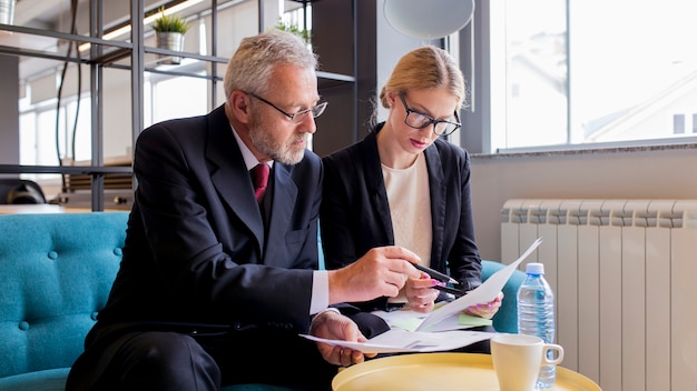 Two businesspeople discussing contract in the office