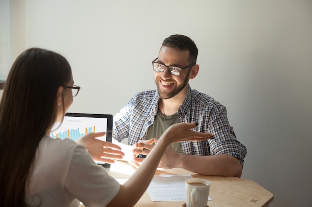 Free photo two businesspeople discussing details of a contract.