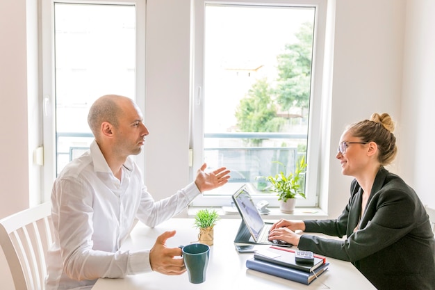 Free Photo two businesspeople having conversation in office