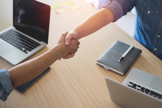 Two Businesspeople shaking hands indoors