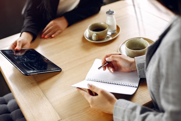 Two businesswomen working in a cafe