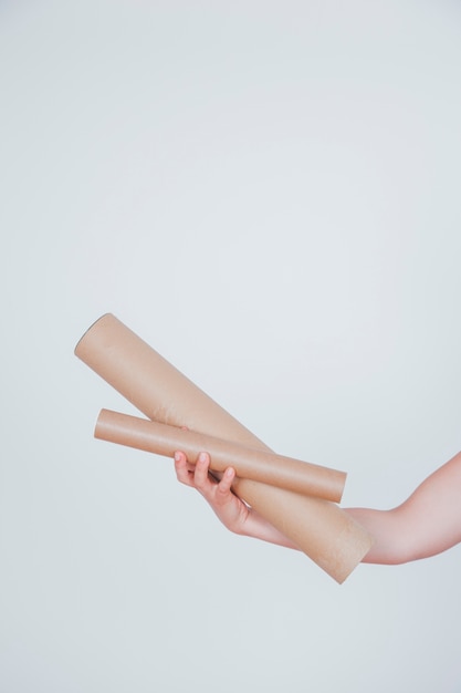 Two cardboard tubes in hand