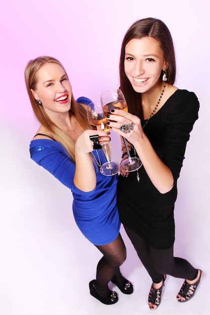 Free Photo two cheerful girlfriends with colorful cocktails