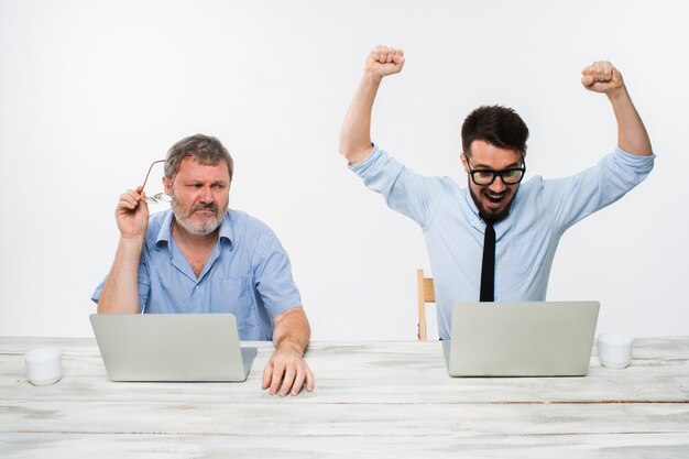 The two colleagues working together at office on white background