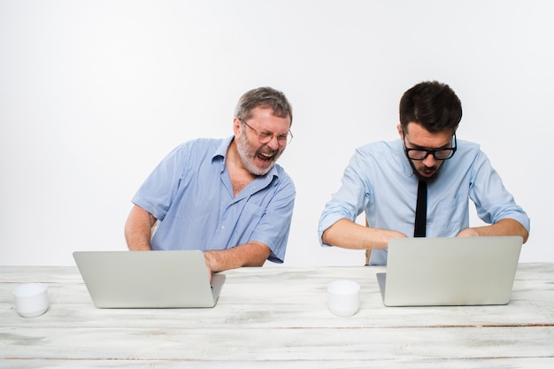 Free photo two colleagues working together at office on white