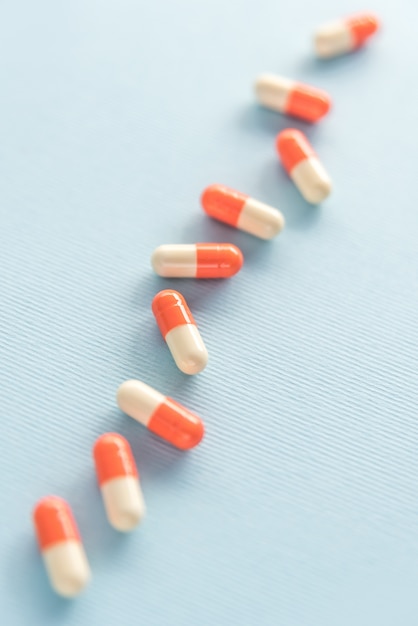 Free Photo two colored medicine capsules in a row