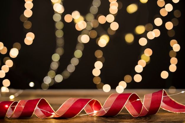 Free photo two-colored ribbon near blurred garland