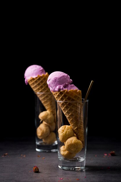 Two cones with ice cream served in glasses