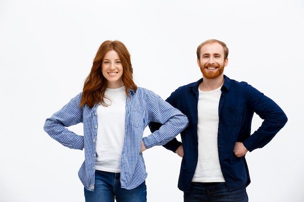 Two confident siblings, redhead couple smiling