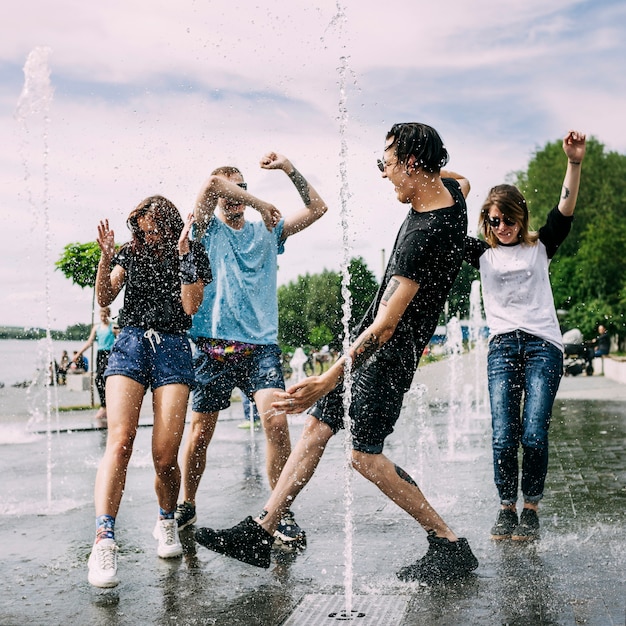 Two couples dancing in the fountain