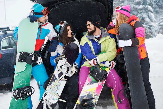 Two couples having fun and snowboarding