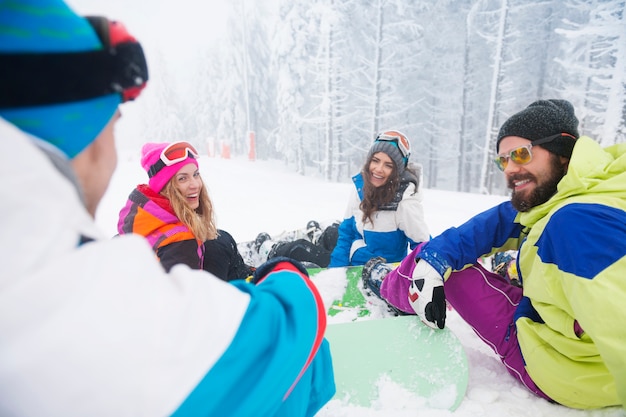 Two couples having fun and snowboarding