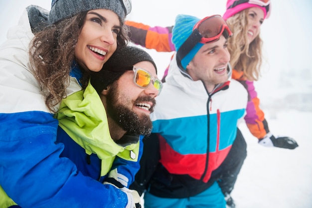 Two couples having fun and snowboarding