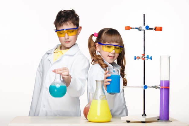 Free photo two cute children at chemistry lesson making experiments