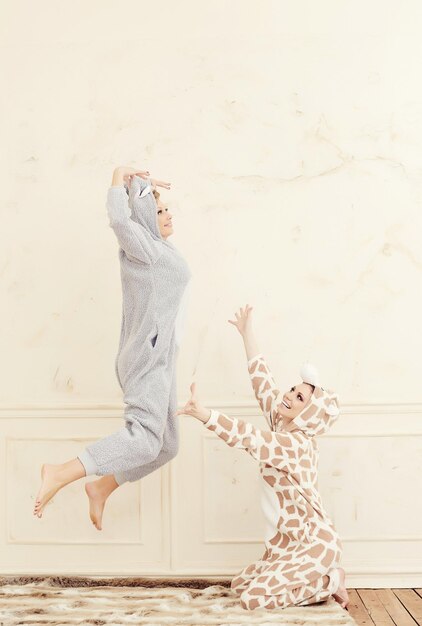 Two cute girls in pajamas having fun.