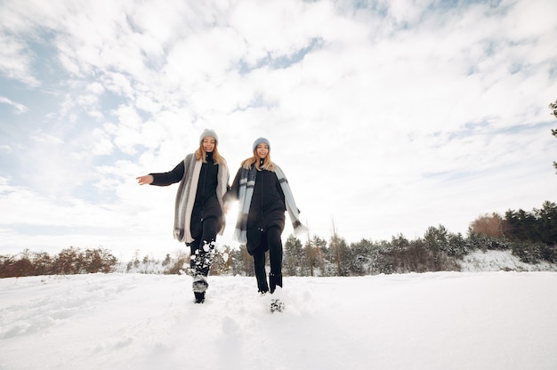 Two cute girls in a winter park