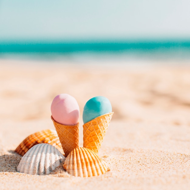 Free photo two delicious ice creams with shells in the beach