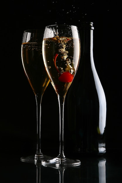 Two elegant glasses with champagne and cherry