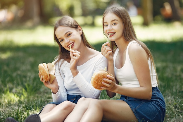 Two elegant and stylish girls in a spring park