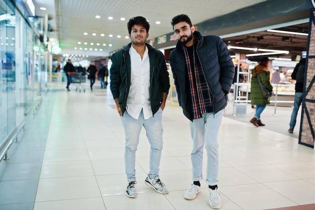 Two fashionable indian guys at shirt and jacket posed on mall Asian man shopping