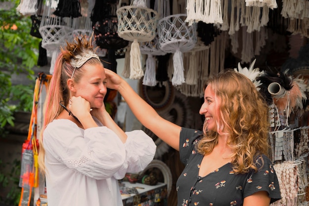 Two female friends having fun at the flea market