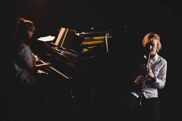 Two female students playing clarinet and piano