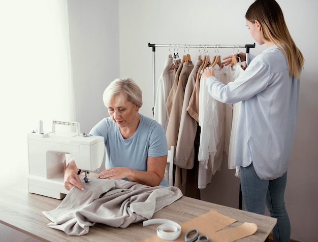 Free photo two female tailors in the studio working together