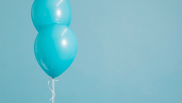 Free photo two floating pastel blue balloons