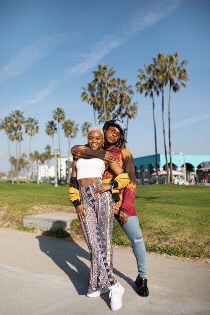 Two friends posing outside in the park